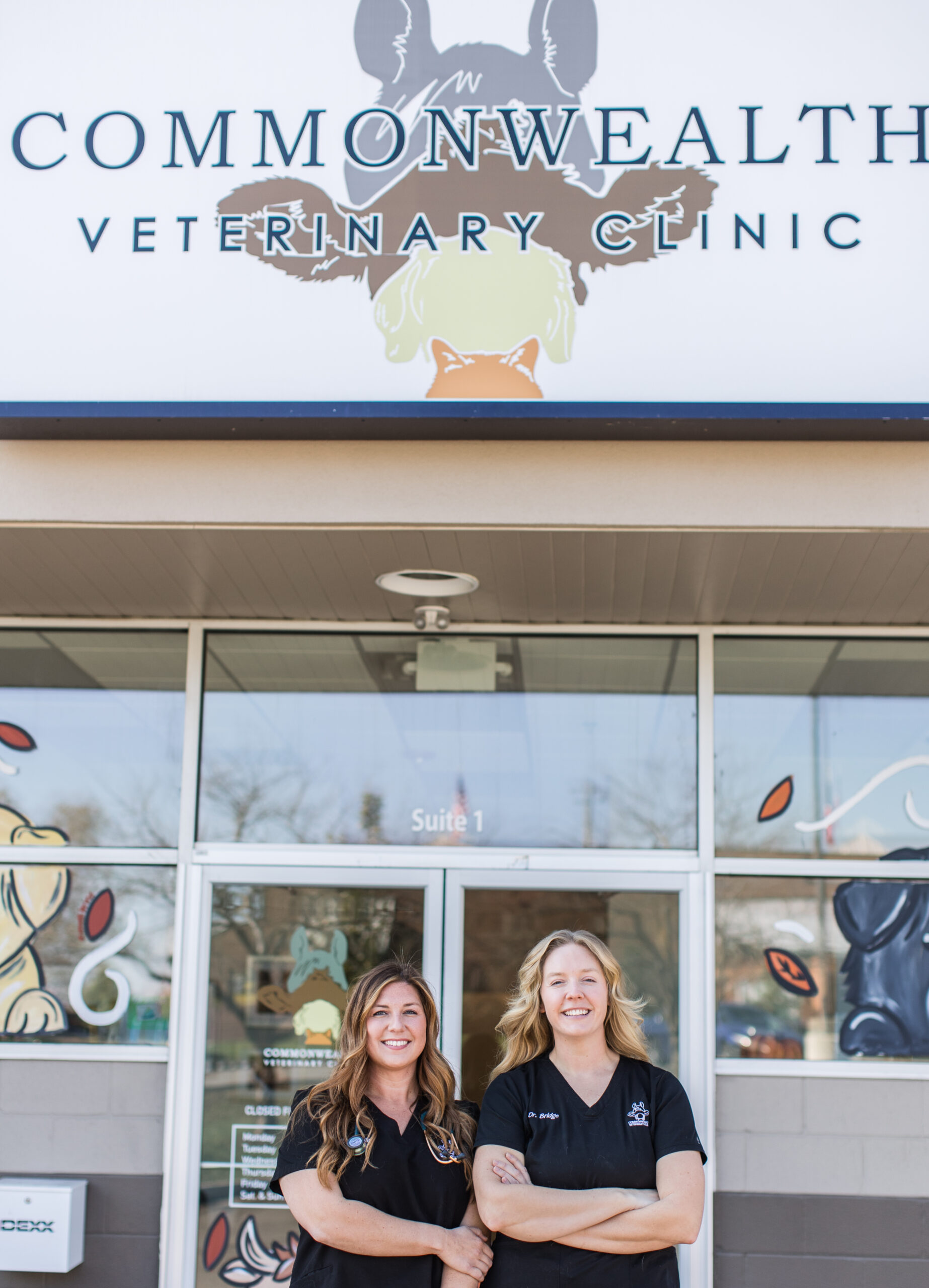 two vets standing in front of a veterinary clinic